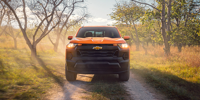 New 2026 Yellow Chevy Colorado Stopped in forest showing its front profile