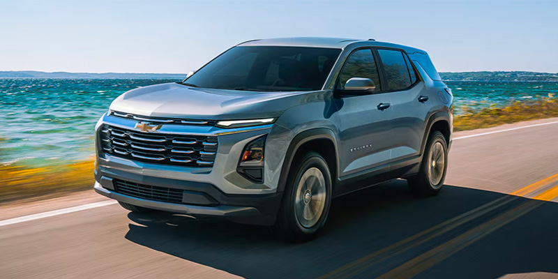 New 2026 Chevrolet Equinox cruising sea-side road