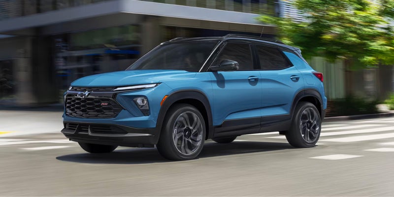 A blue 2026 Chevrolet Trailblazer driving down the road.